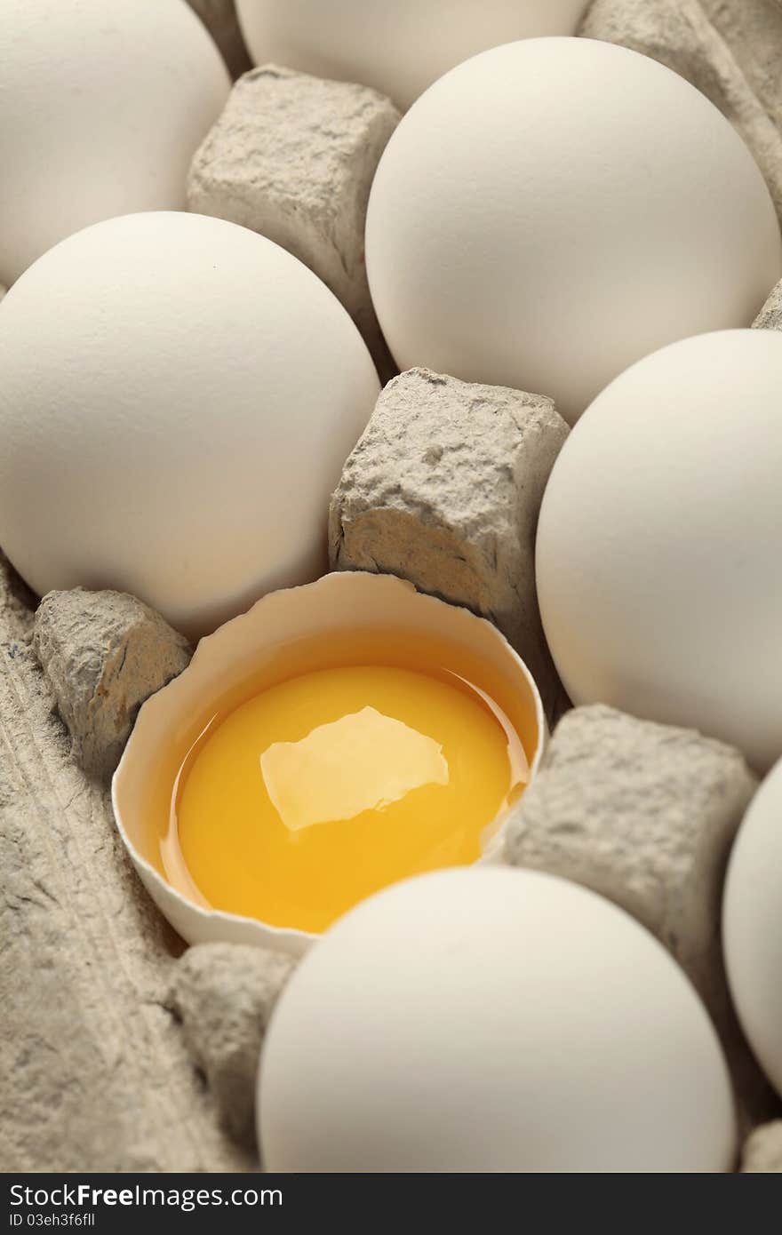 Tray of white eggs on white background