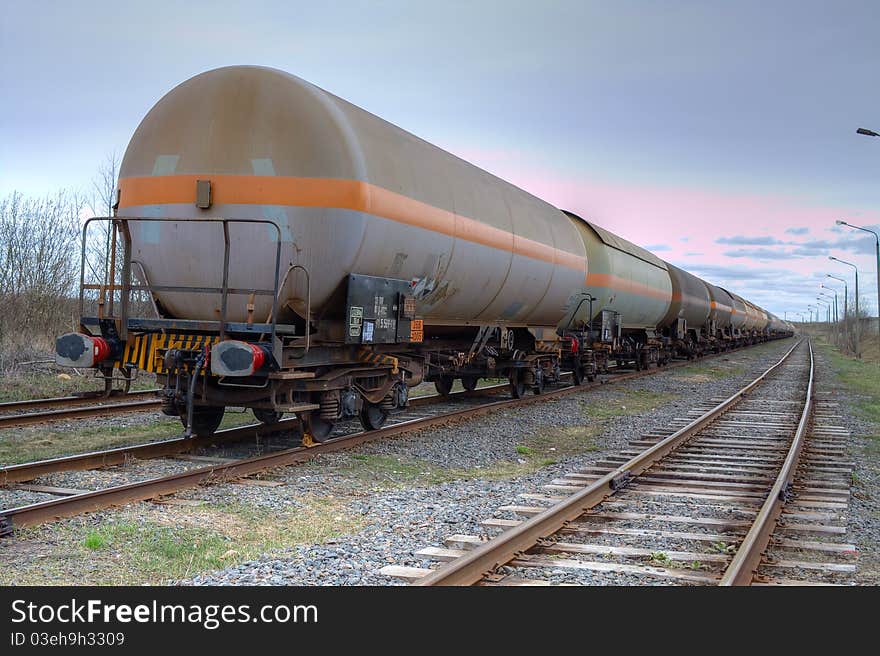 Tanks with fuel being transported by rail, taken in backlit. Tanks with fuel being transported by rail, taken in backlit