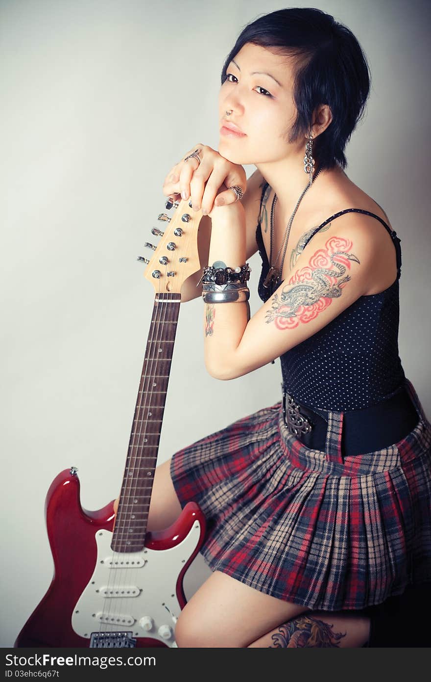 Funky young woman with her red hot guitar. Funky young woman with her red hot guitar.