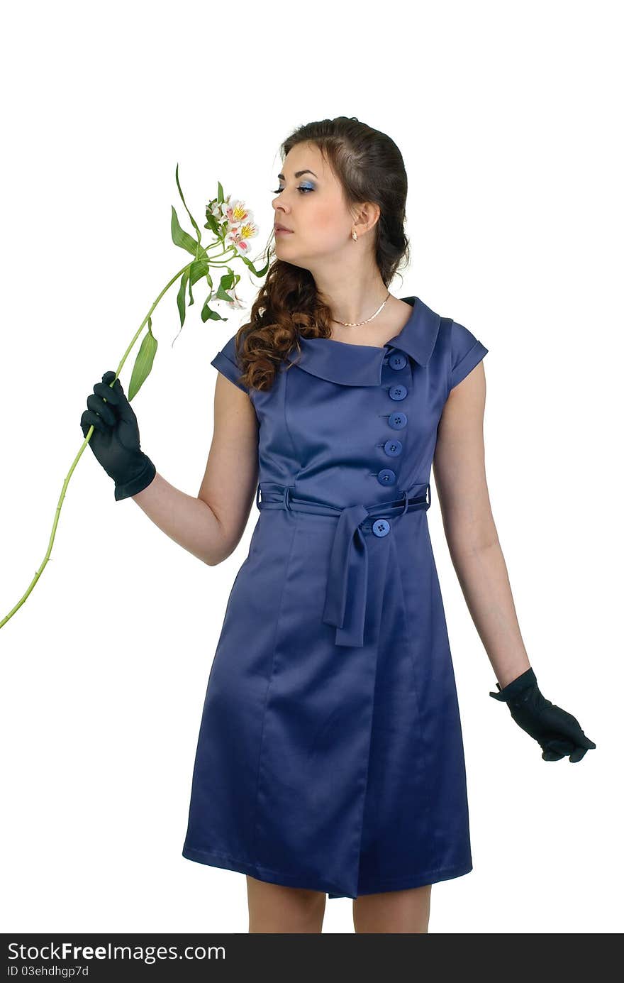 Young cute woman in blue dress with flower posing in studio. Young cute woman in blue dress with flower posing in studio