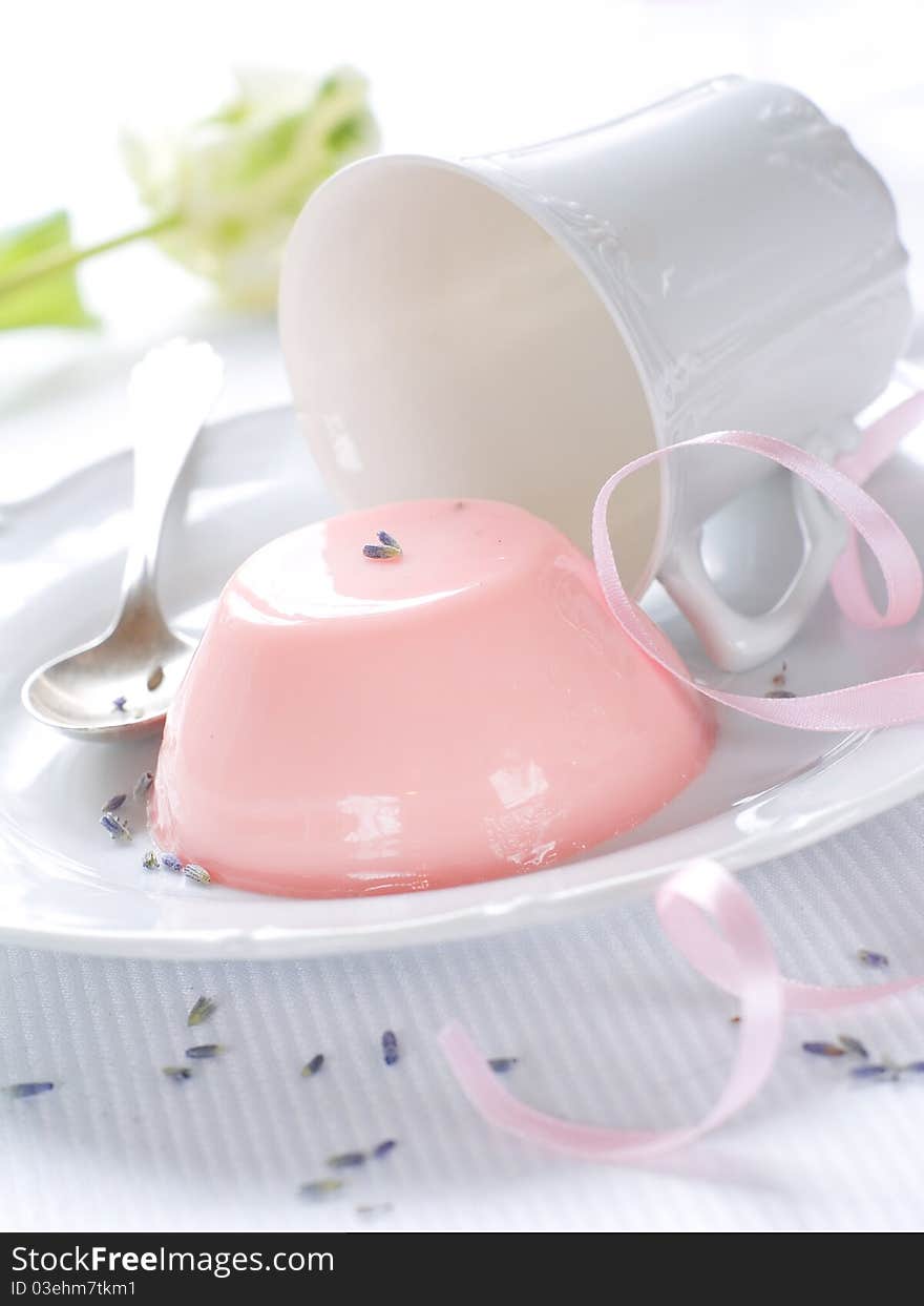 Panna Cotta (cream dessert) with cup on flower on background