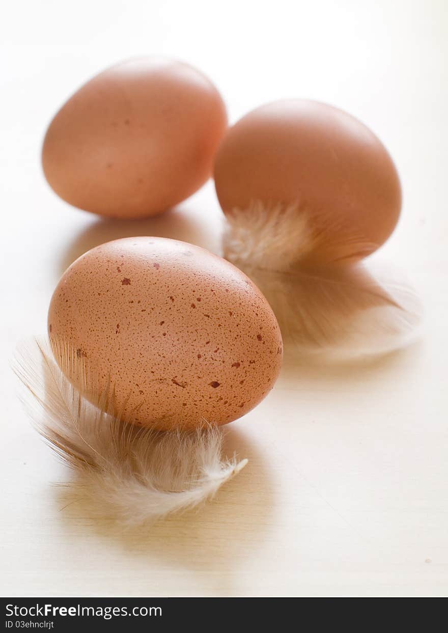 Three ecological brown eggs on wooden table