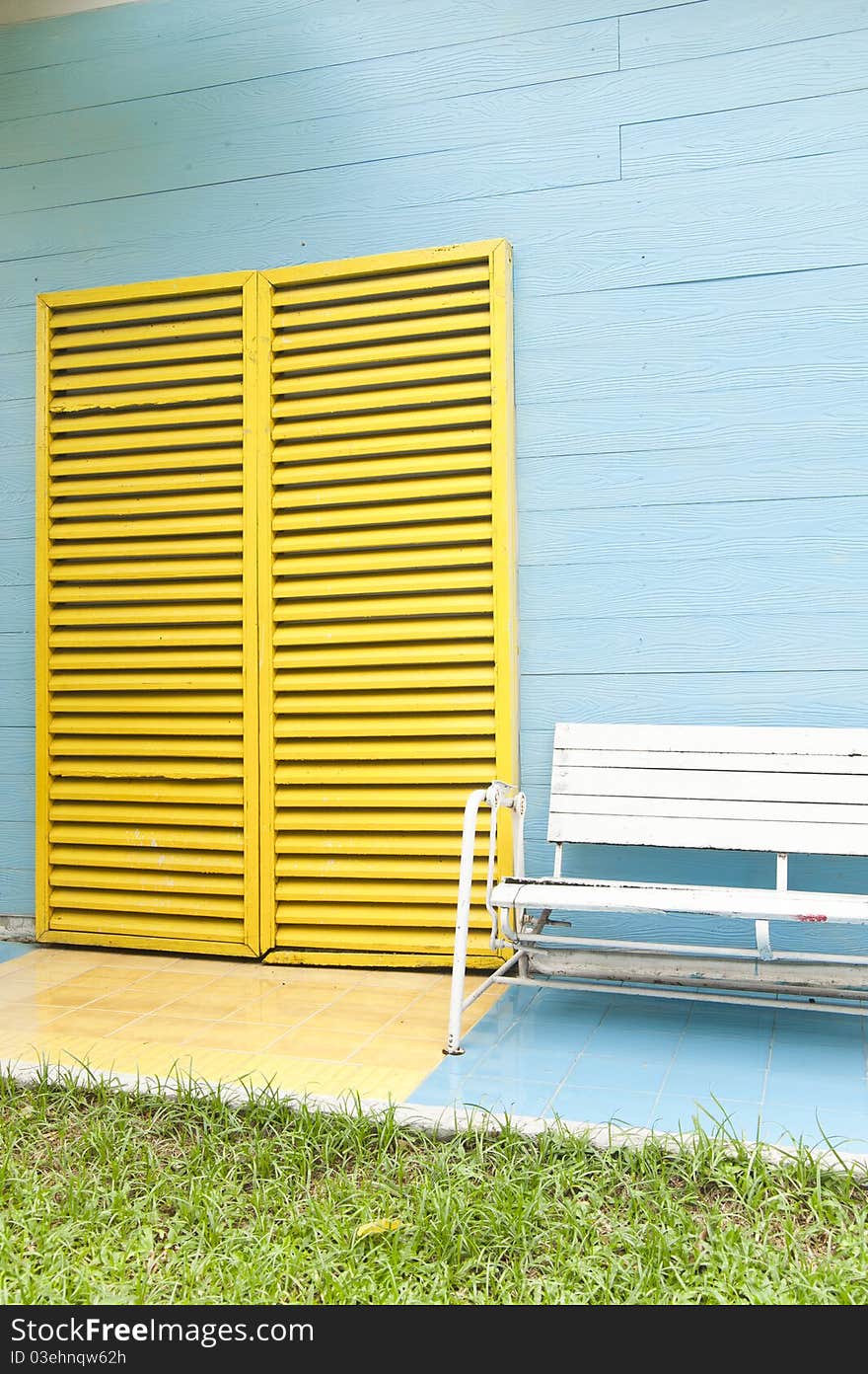 White bench and yellow door