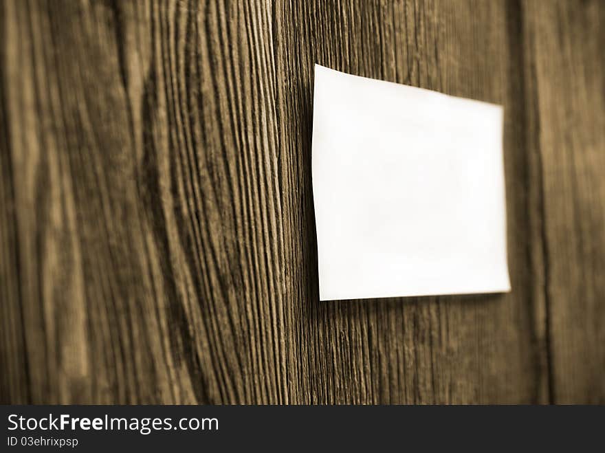 Square white sheet on a wooden fence