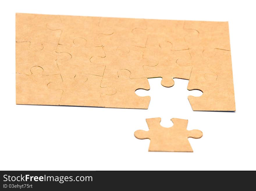 Cardboard jigsaw puzzle isolated on white background