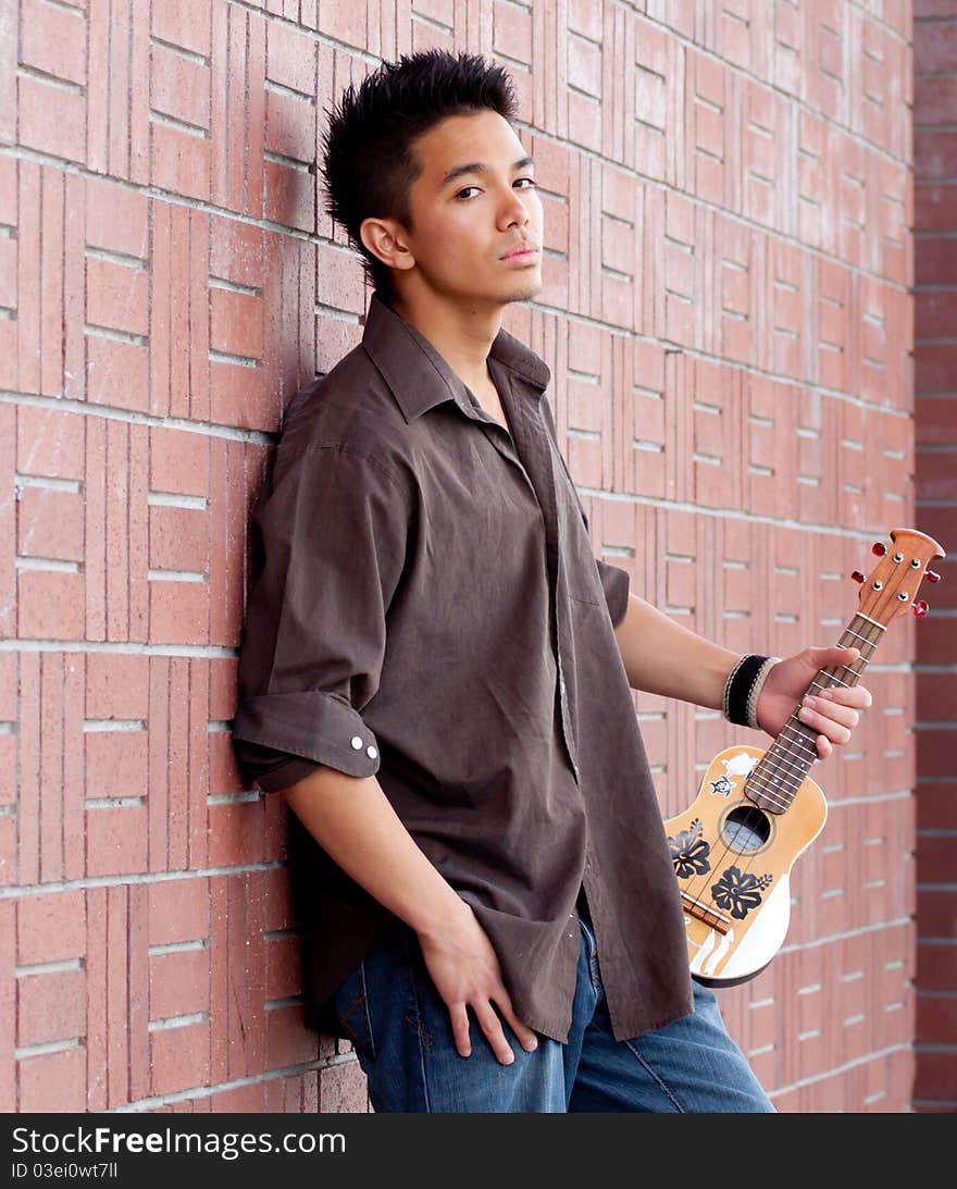 A photograph of a handsome young man with his Ukelele. A photograph of a handsome young man with his Ukelele