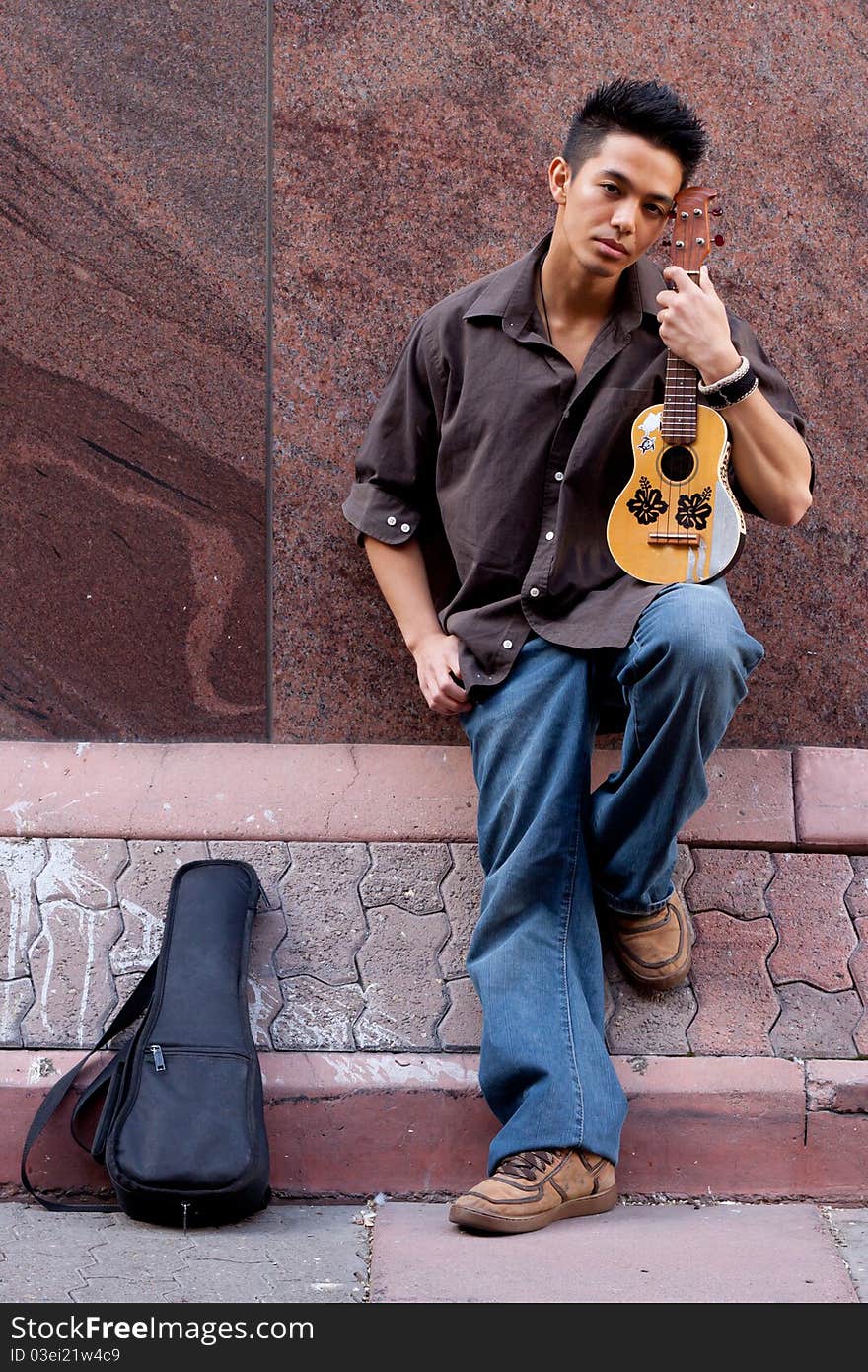 A photograph of a handsome young man with his Ukelele. A photograph of a handsome young man with his Ukelele