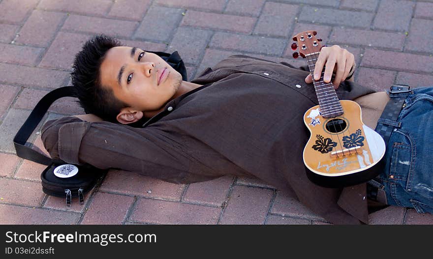 A photograph of a young man leaned against a tree. A photograph of a young man leaned against a tree.