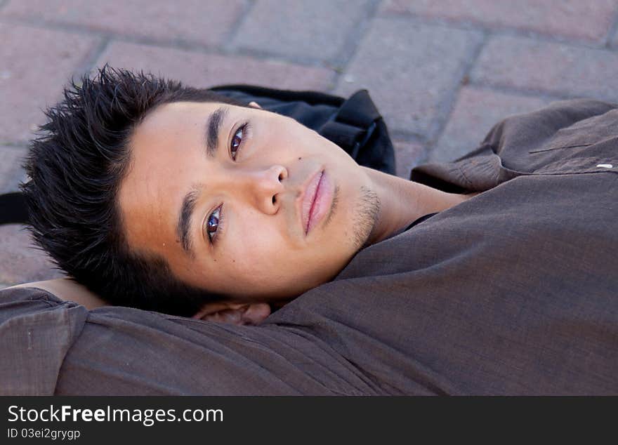 A photograph of a young man leaned against a tree. A photograph of a young man leaned against a tree.