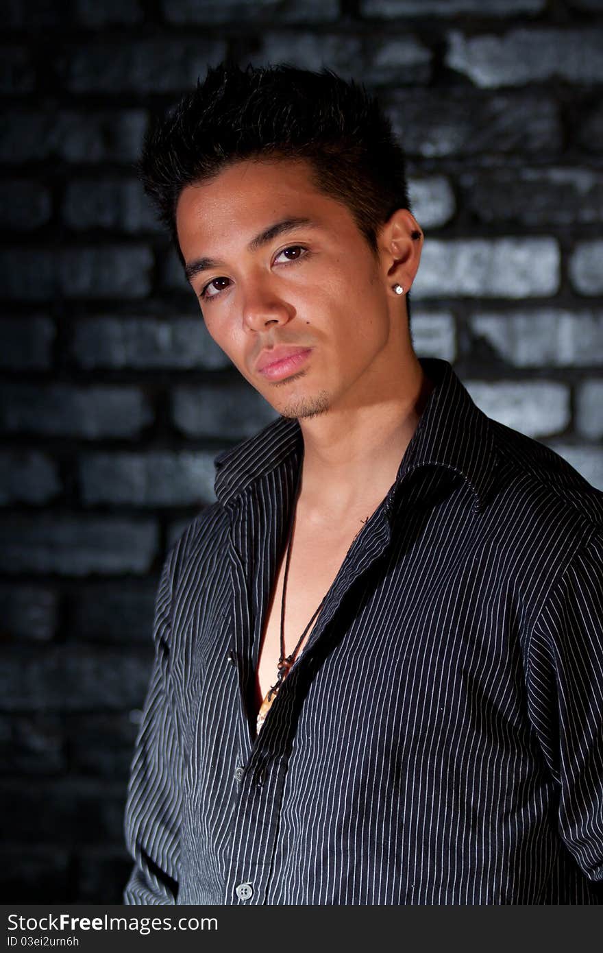 A nice image of a young man in front of a brick background. A nice image of a young man in front of a brick background.