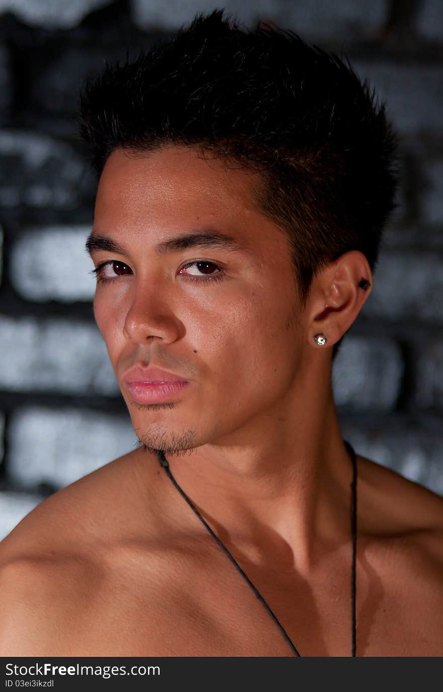 A nice image of a young man in front of a brick background. A nice image of a young man in front of a brick background.