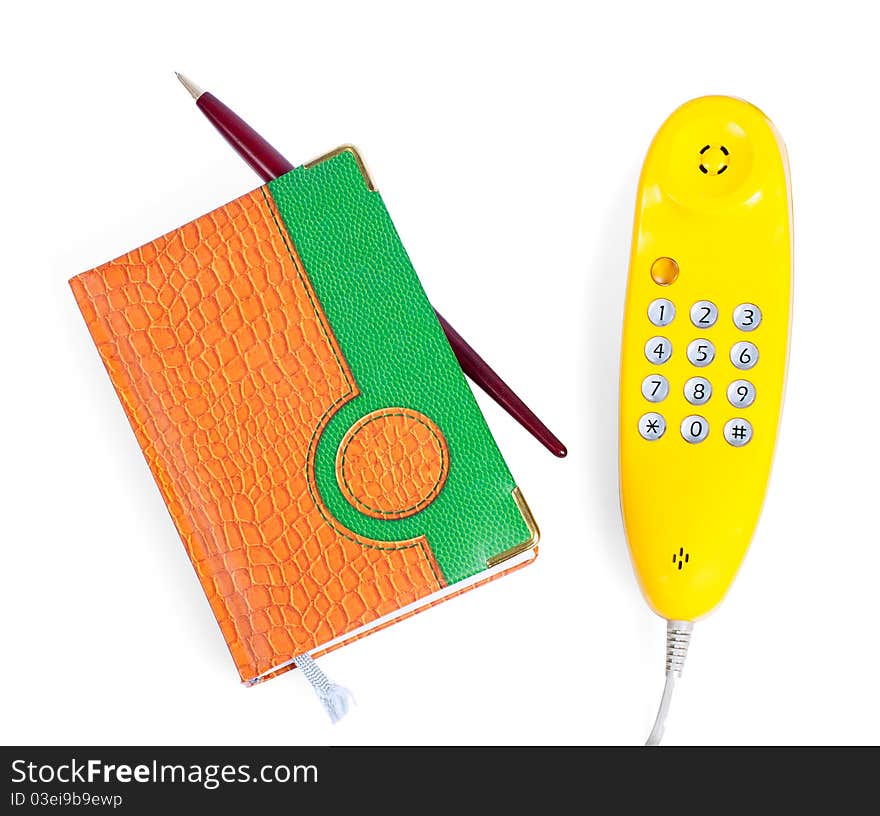 Yellow handset and notebook, isolated on white. Yellow handset and notebook, isolated on white