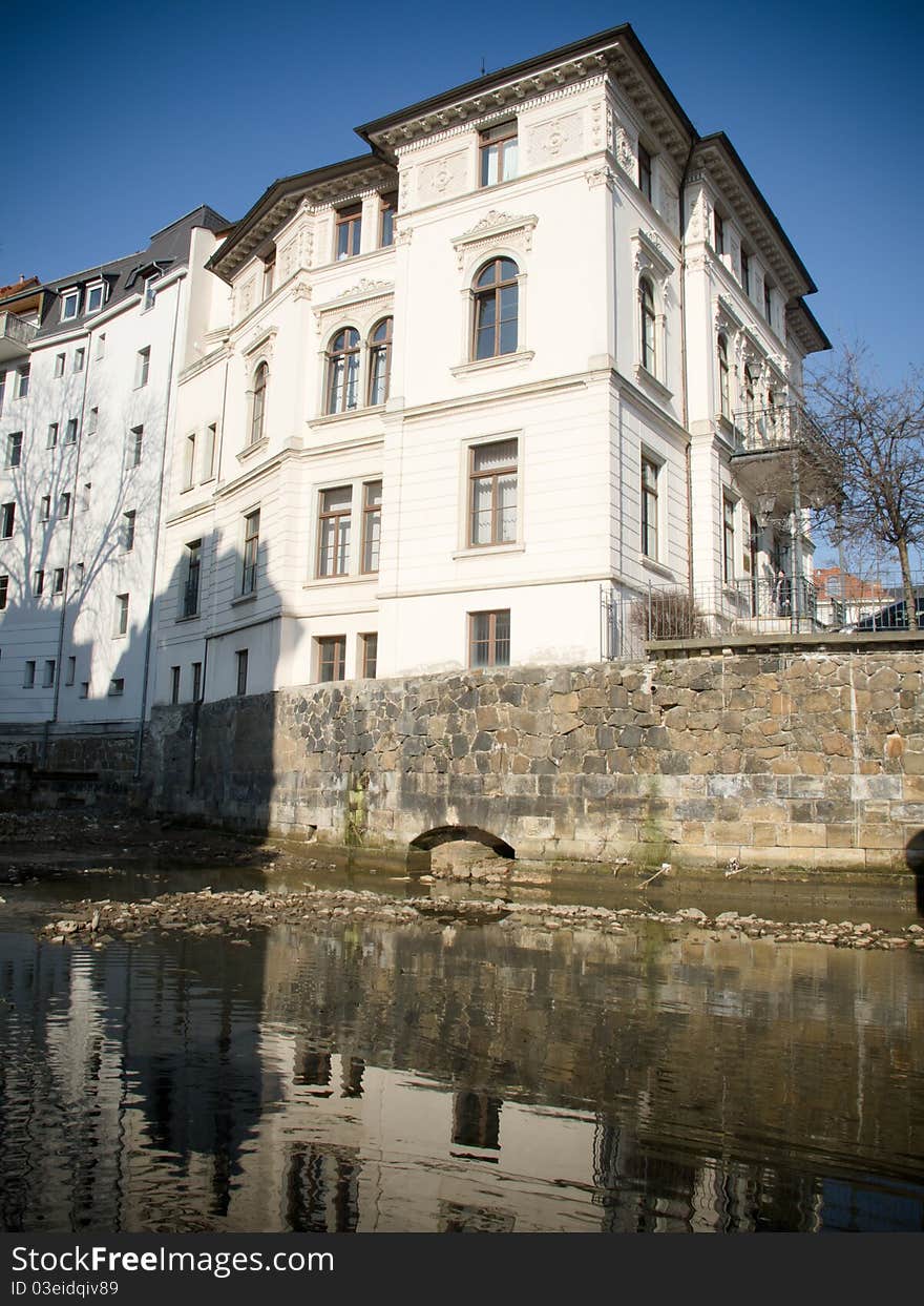 Old historical buildings in Leipzig are reflecting in water