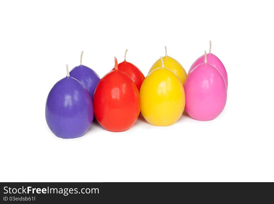 Easter candles in the shape of eggs on the white background