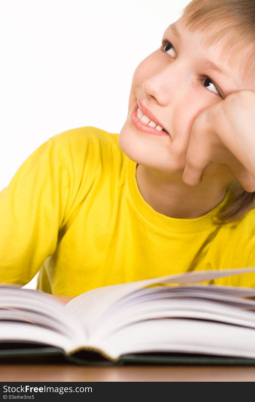 Boy in a yellow reading a book