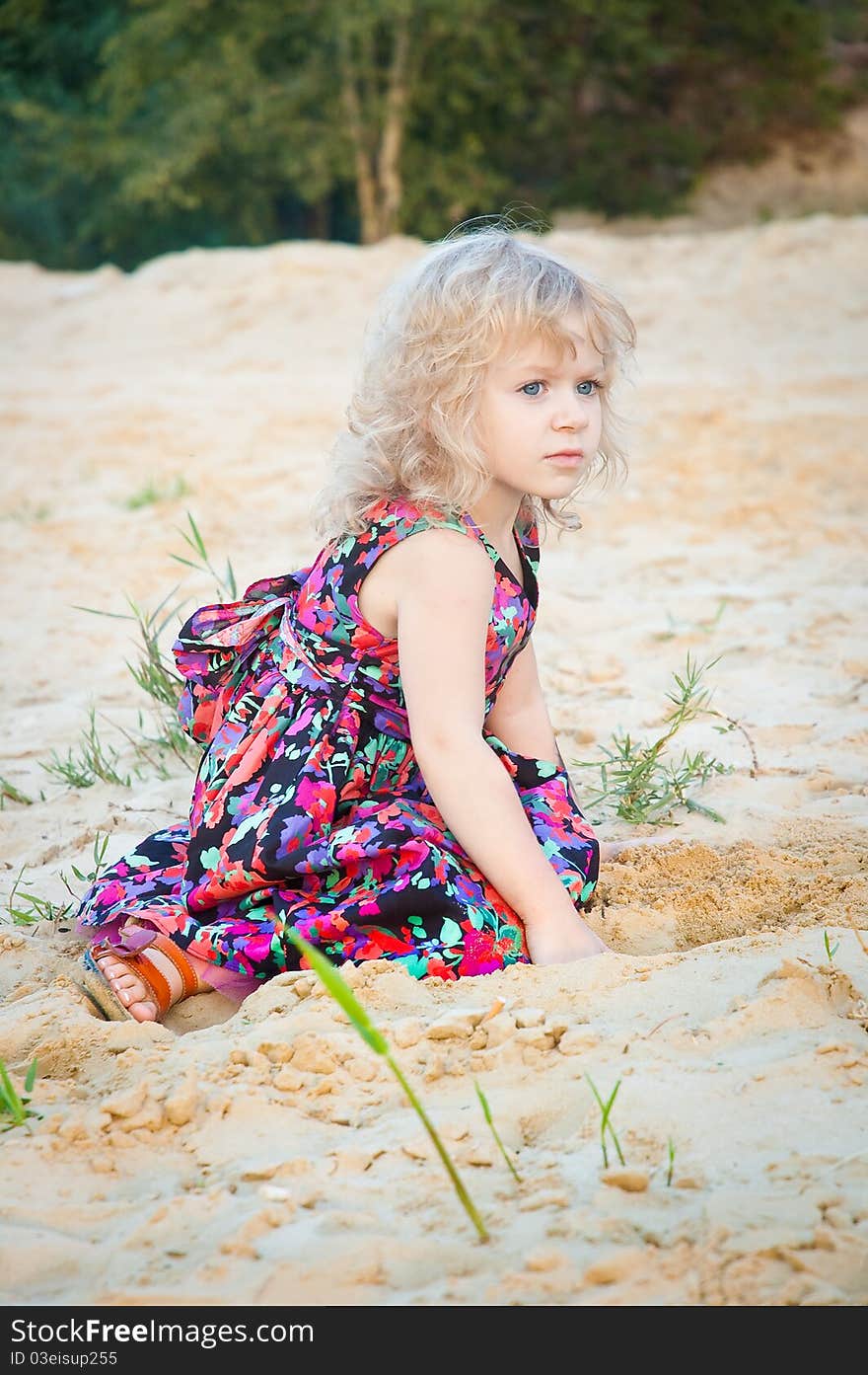 Little girl plaing alone on riverside in summer. Little girl plaing alone on riverside in summer