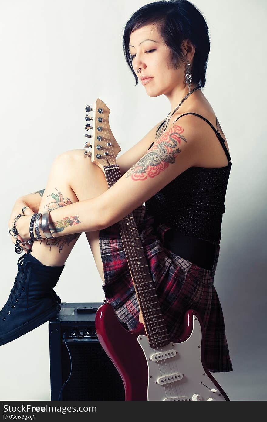 Funky young woman with her red hot guitar. Funky young woman with her red hot guitar.