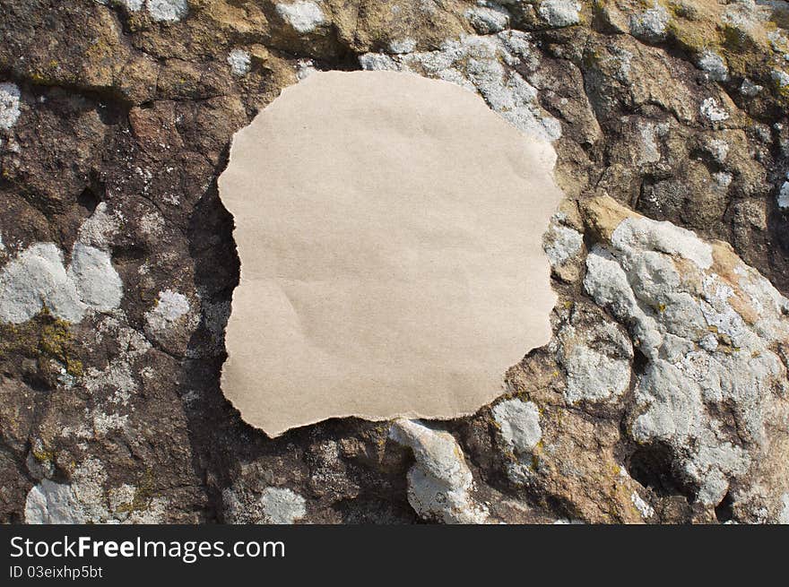 Empty Piece of Paper on Rock Background