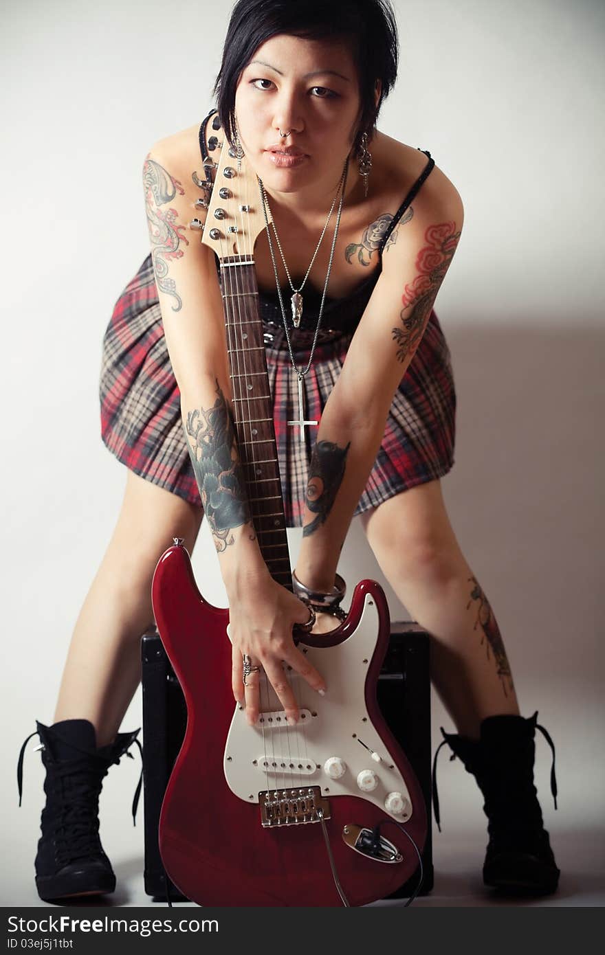 Funky young woman with her red hot guitar. Funky young woman with her red hot guitar.