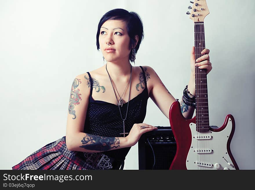 Funky young woman with her red hot guitar. Funky young woman with her red hot guitar.