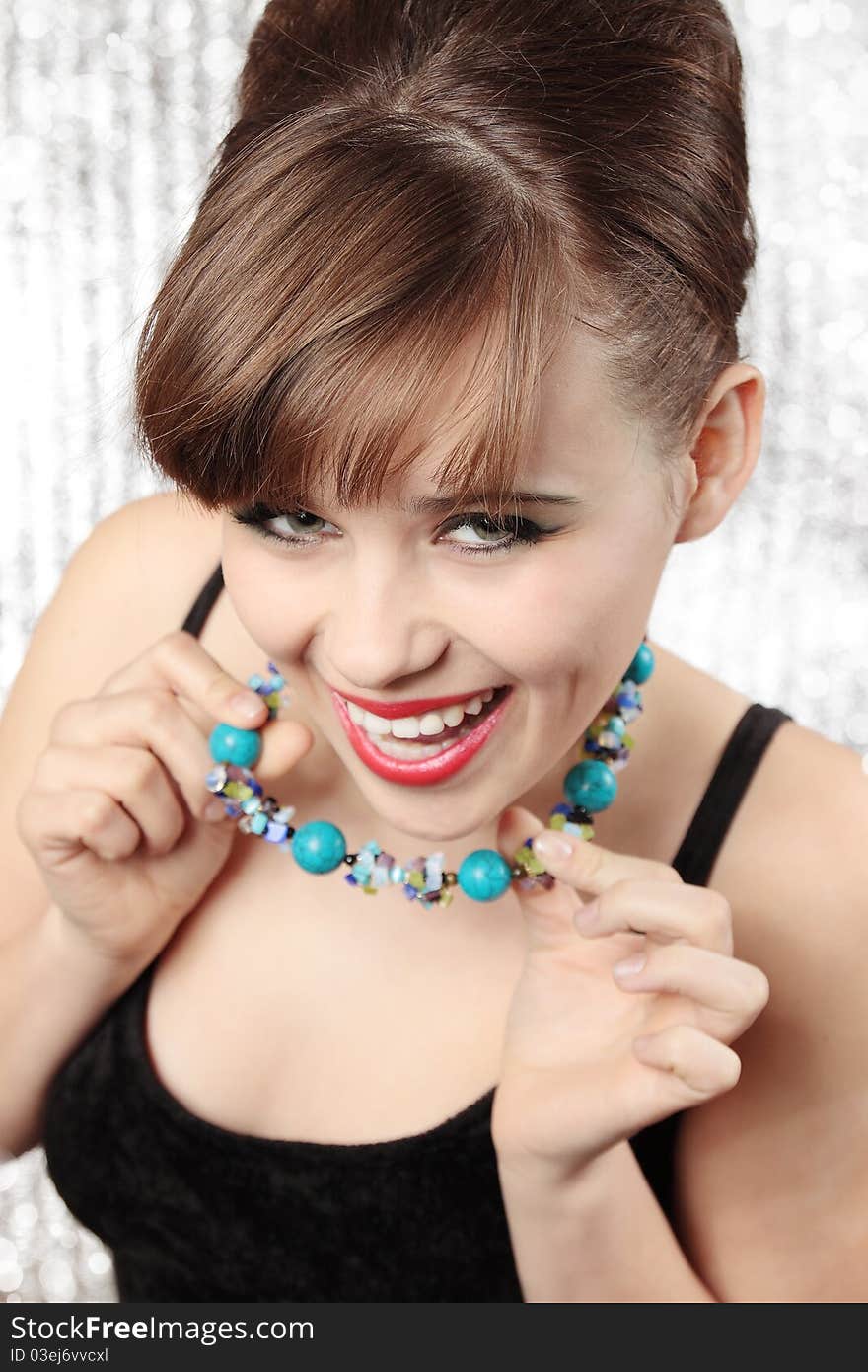 Happy young woman in the beads from turquoise. Happy young woman in the beads from turquoise