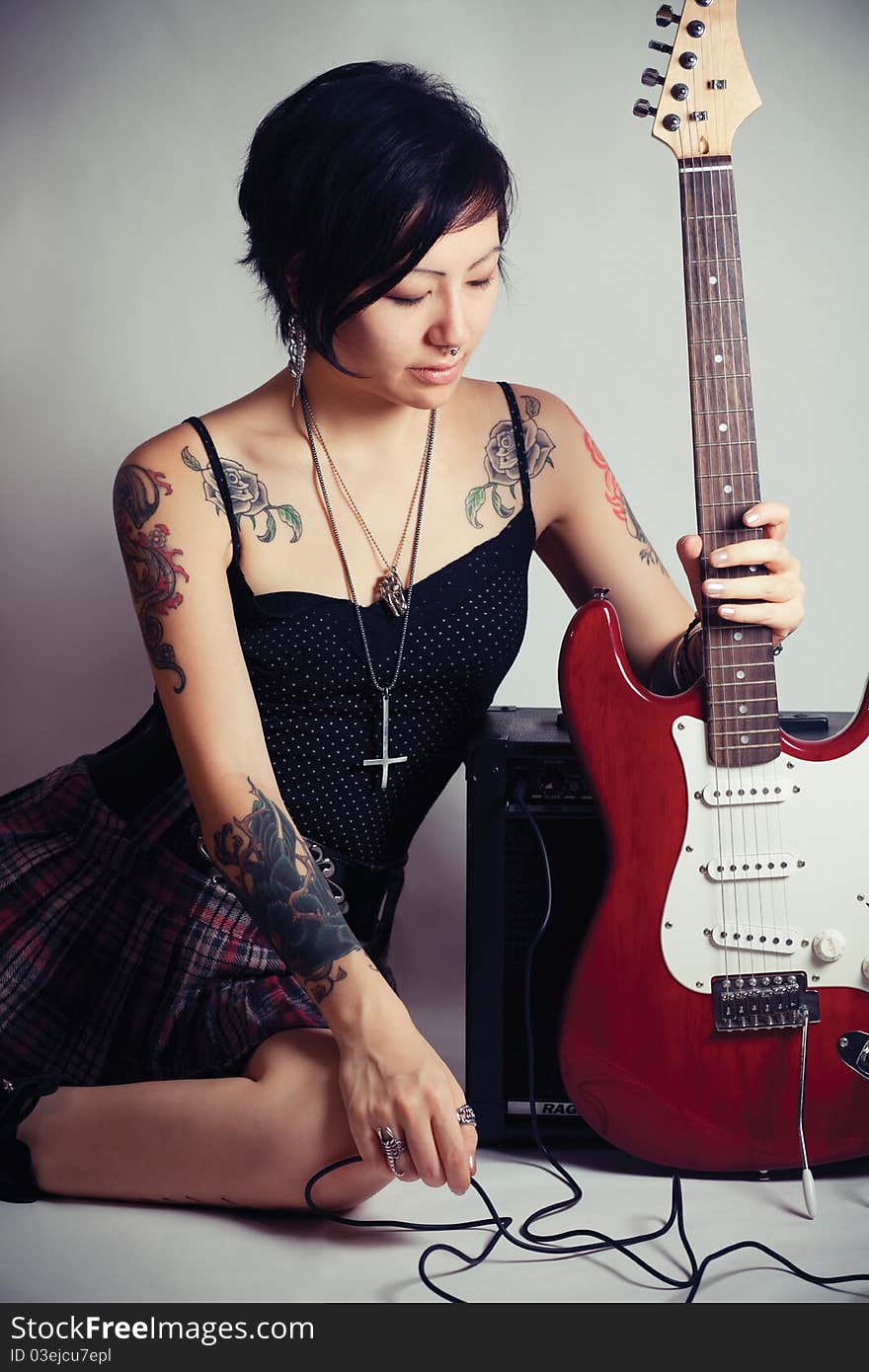 Funky young woman with her red hot guitar. Funky young woman with her red hot guitar.