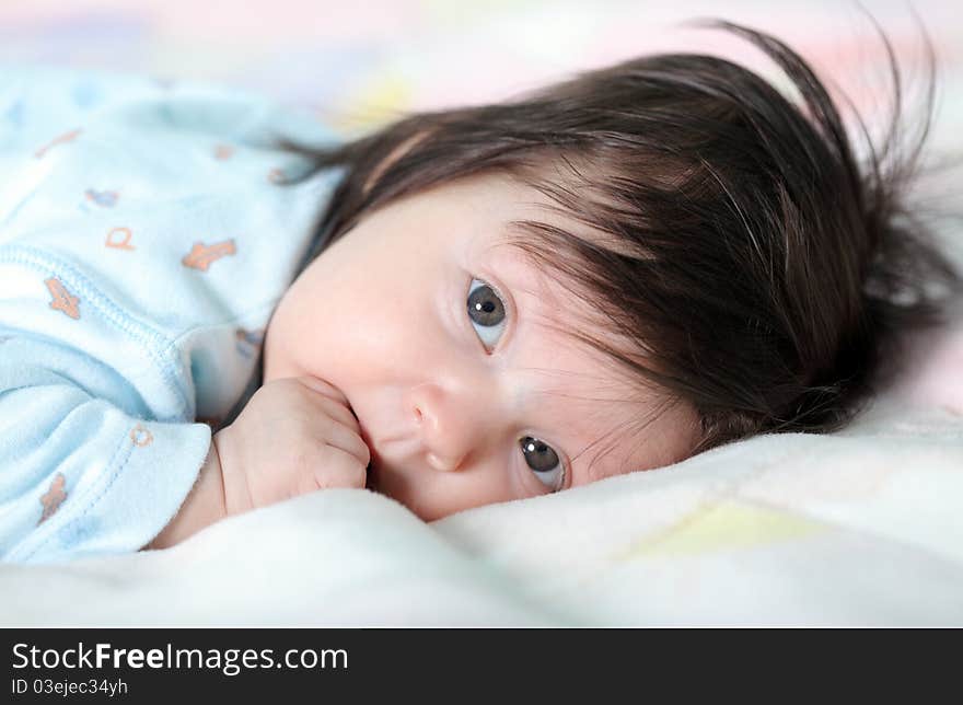 Beautiful baby lying on the bed. Beautiful baby lying on the bed