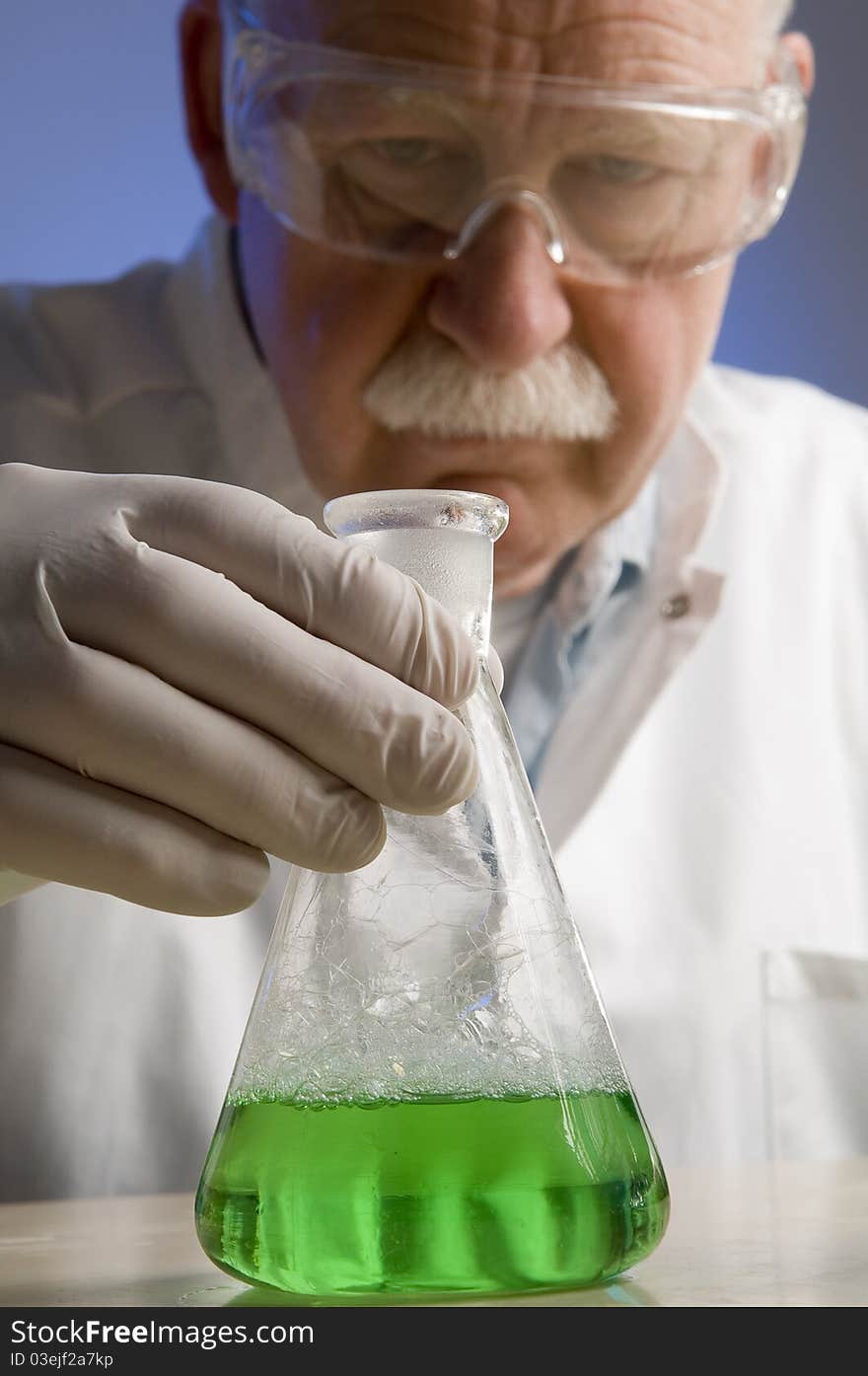 Chemist looking closely at his latest discovery. Chemist looking closely at his latest discovery