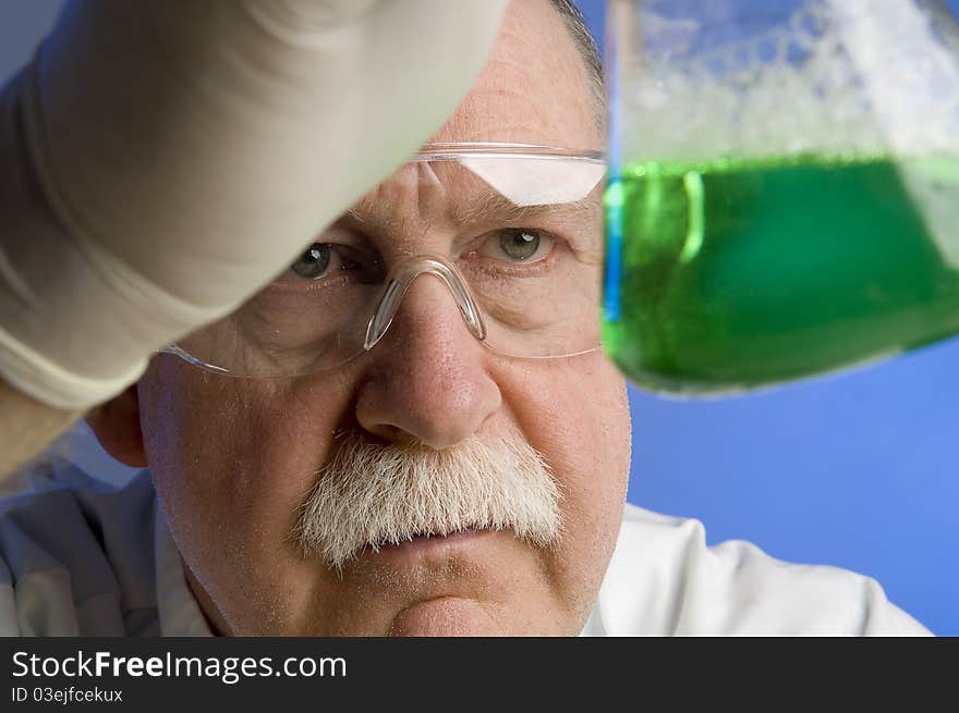 Chemist looking closely at his latest discovery. Chemist looking closely at his latest discovery