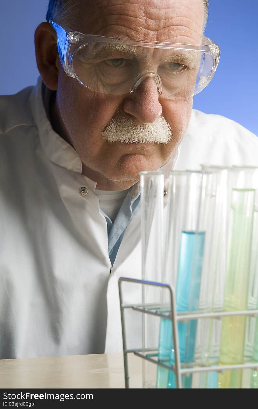 Chemist looking closely at his latest discovery. Chemist looking closely at his latest discovery