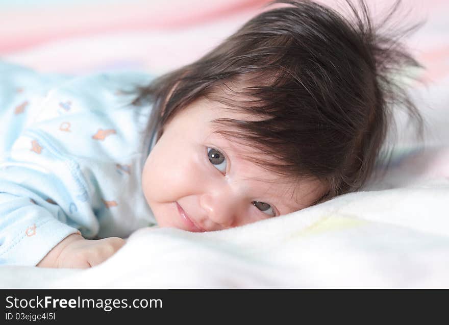 Beautiful baby lying on the bed. Beautiful baby lying on the bed