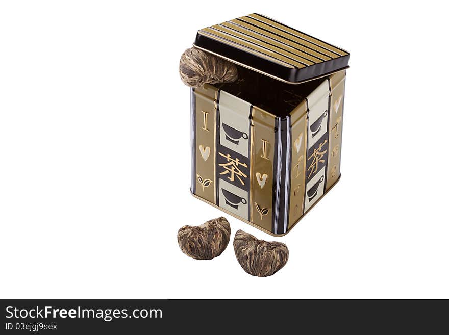 Opened tea box with ornate and heart-shaped tea leaves. Opened tea box with ornate and heart-shaped tea leaves