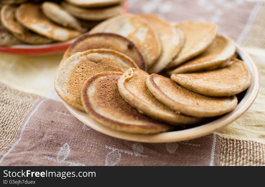 Stack of sweet oat pancakes on ceramic plate. Stack of sweet oat pancakes on ceramic plate