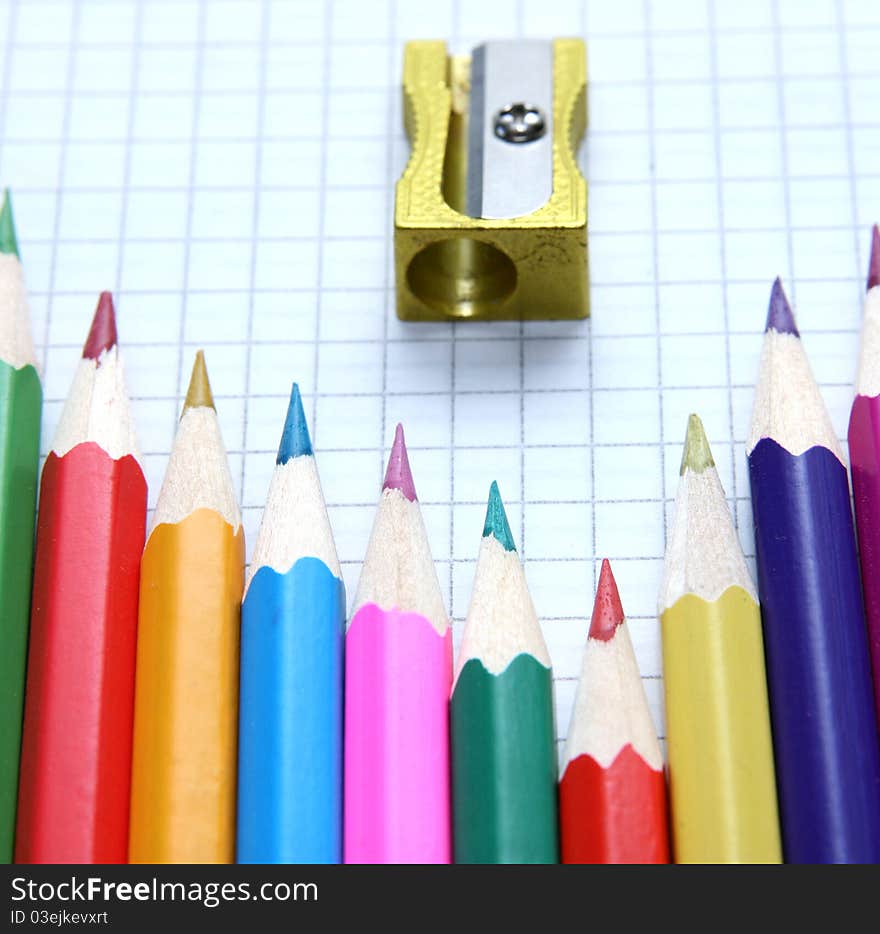 Pencils and sharpeners lying on paper