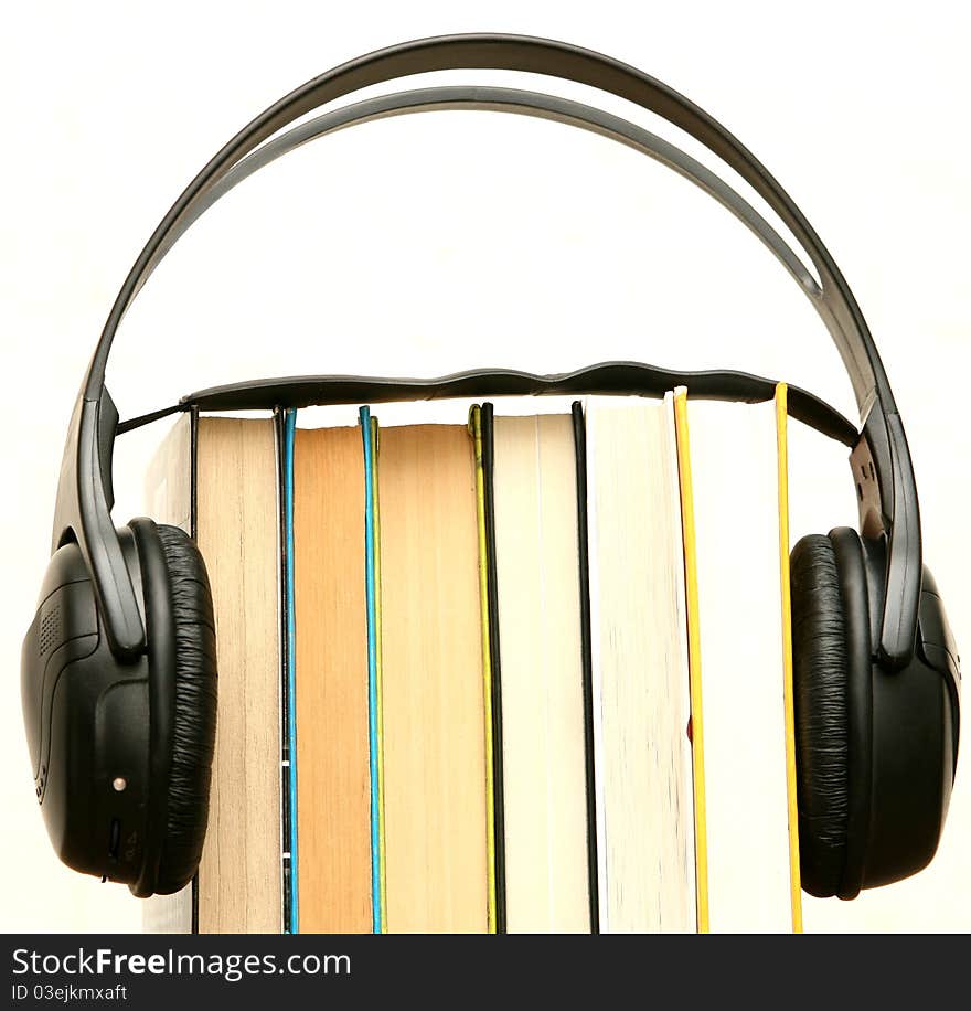 Headphones attached to a pile of books. Headphones attached to a pile of books