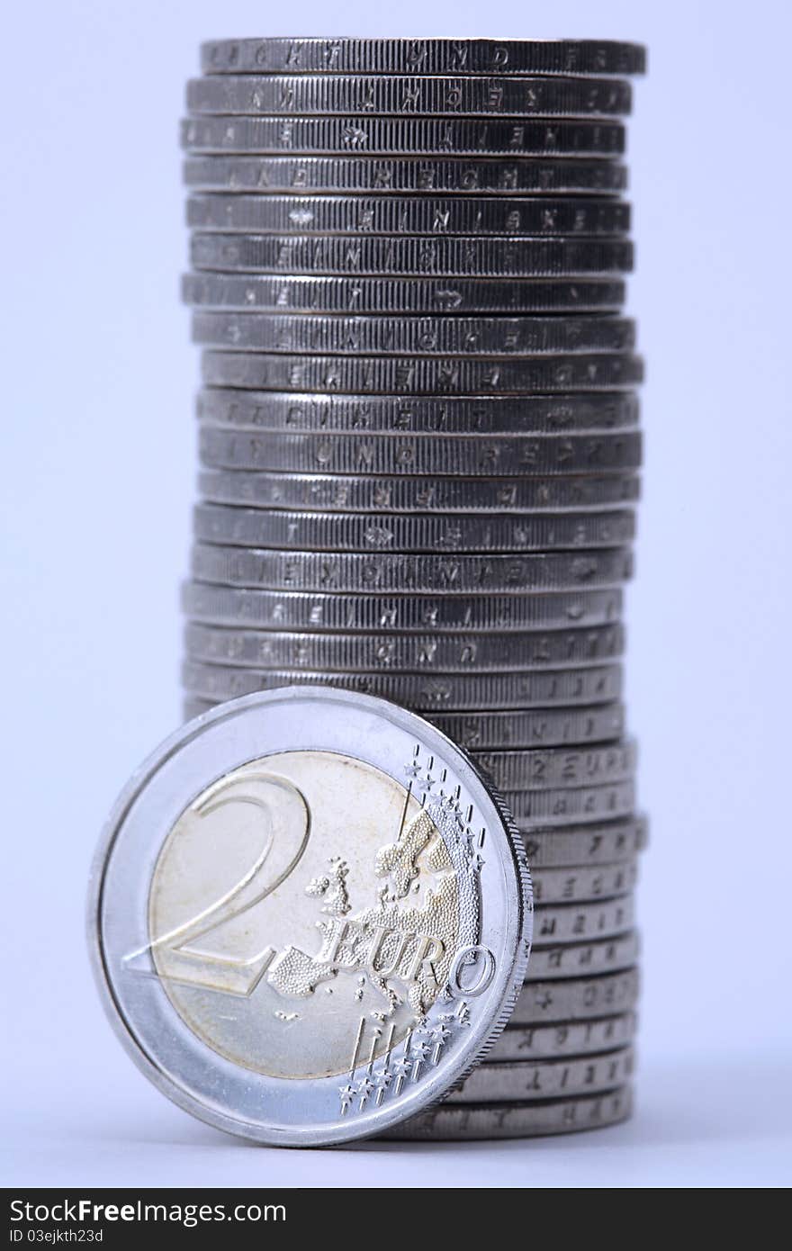 Stack of Euro coins in blue light