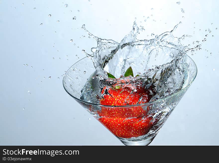 Strawberry falling into the water