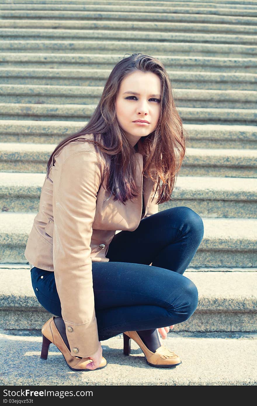 Portrait of pretty girl  sitting  on the stairc