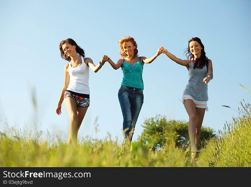 Fun smile girlfriends run by green field sun is shine. Fun smile girlfriends run by green field sun is shine