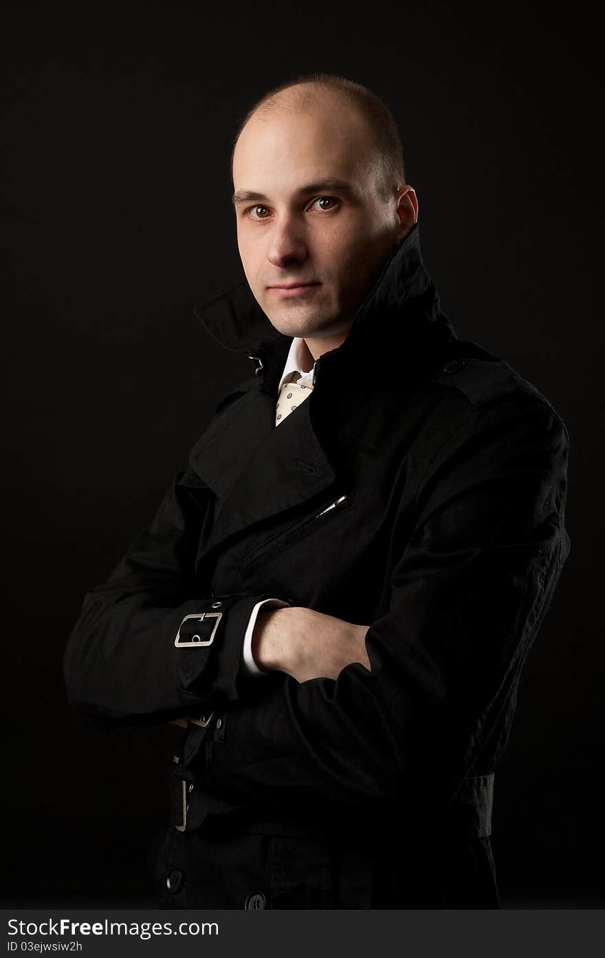 Portrait of young man thinking, black background