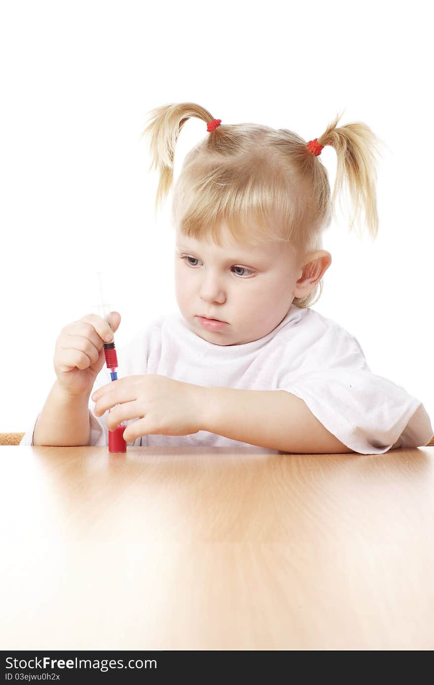 Child playing with a syringe