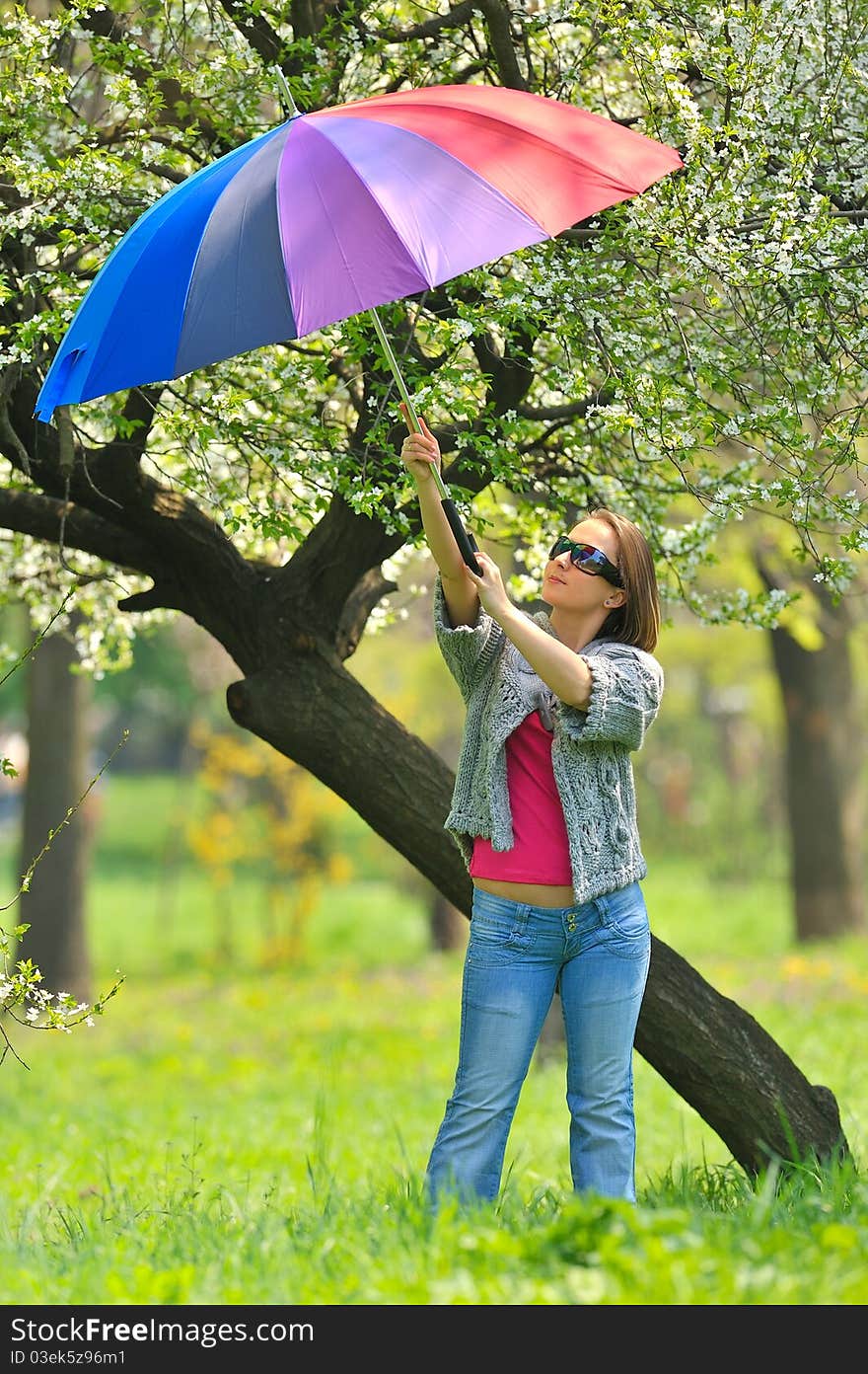 Beautiful woman with umbrella in rainbow colors