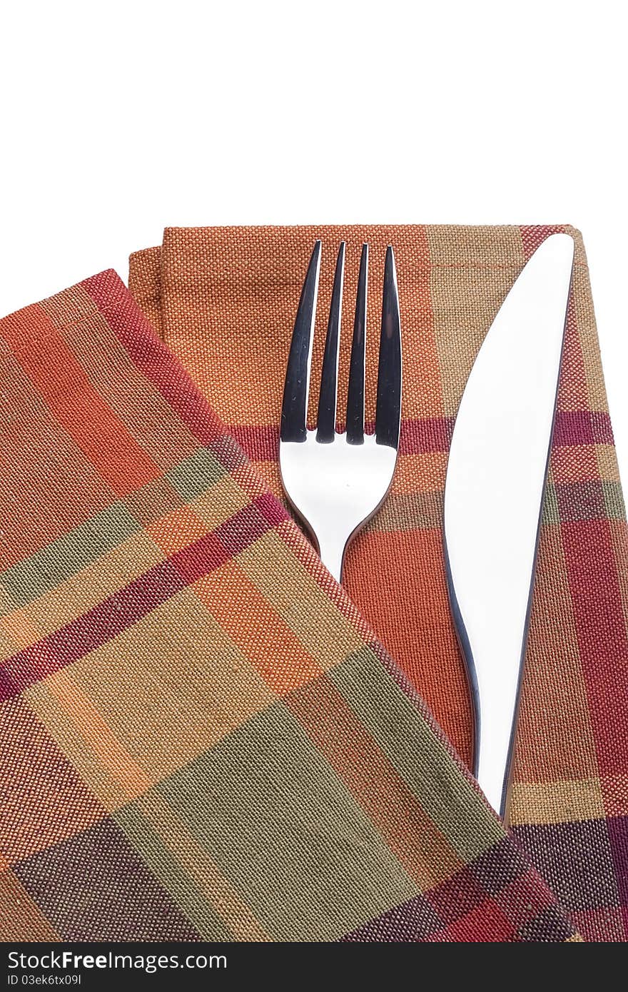 Knife and fork on a red napkin - tableware.