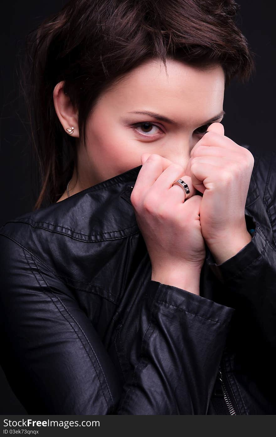 Attractive sexy girl in a black coat posing. Attractive sexy girl in a black coat posing