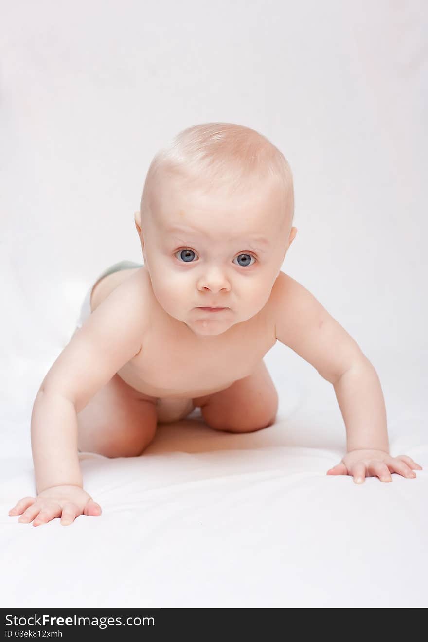 Newborn baby lying in a bed