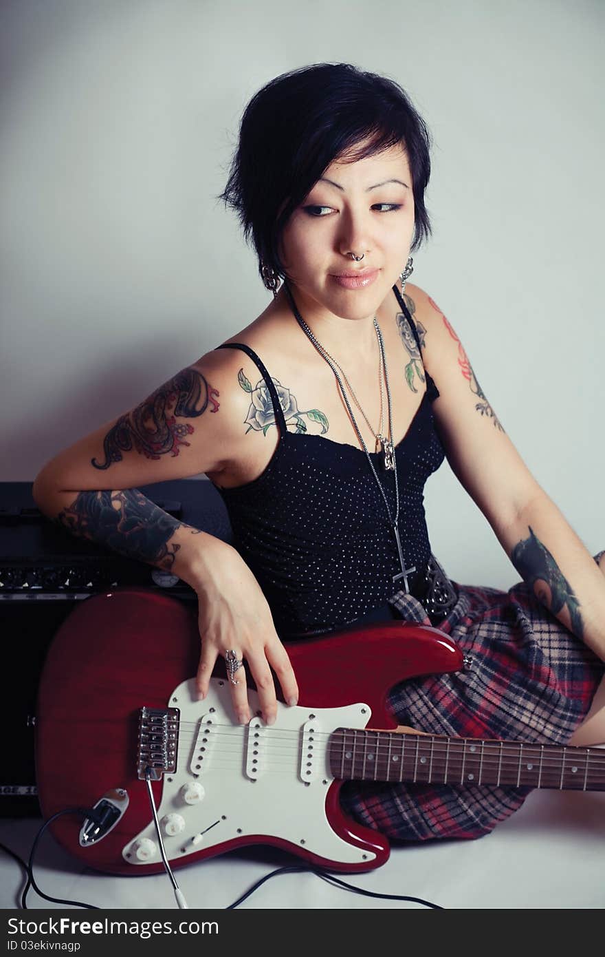 Funky young woman with her red hot guitar. Funky young woman with her red hot guitar.