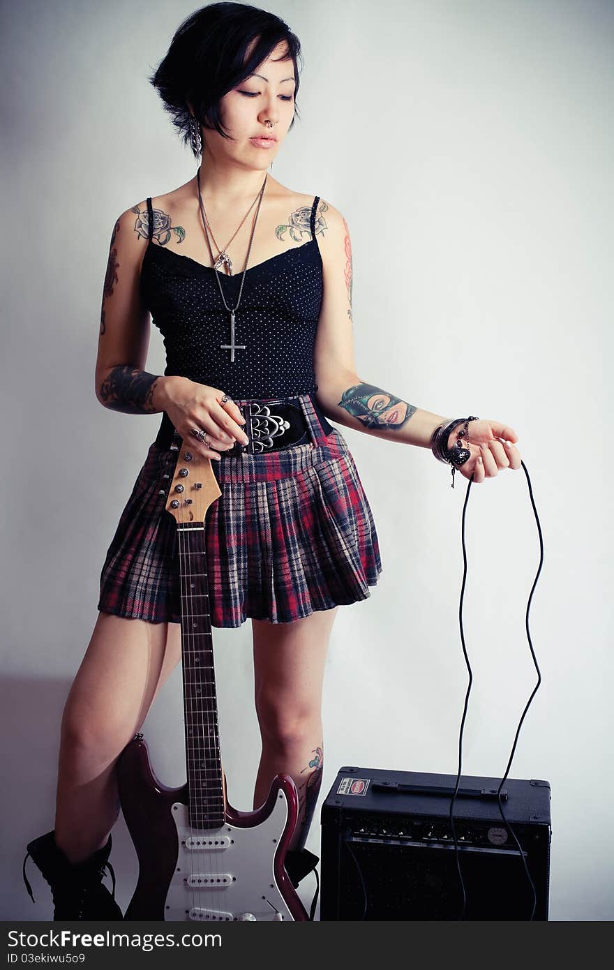 Funky young woman with her red hot guitar. Funky young woman with her red hot guitar.