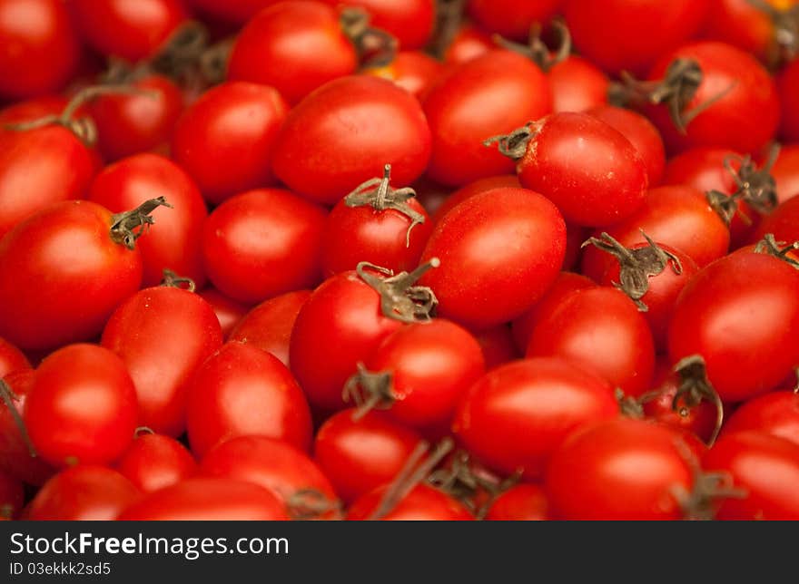 A background of fresh vine tomatoes for sale at a market