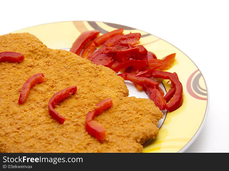 Escalope breaded with paprika patrols onto plates