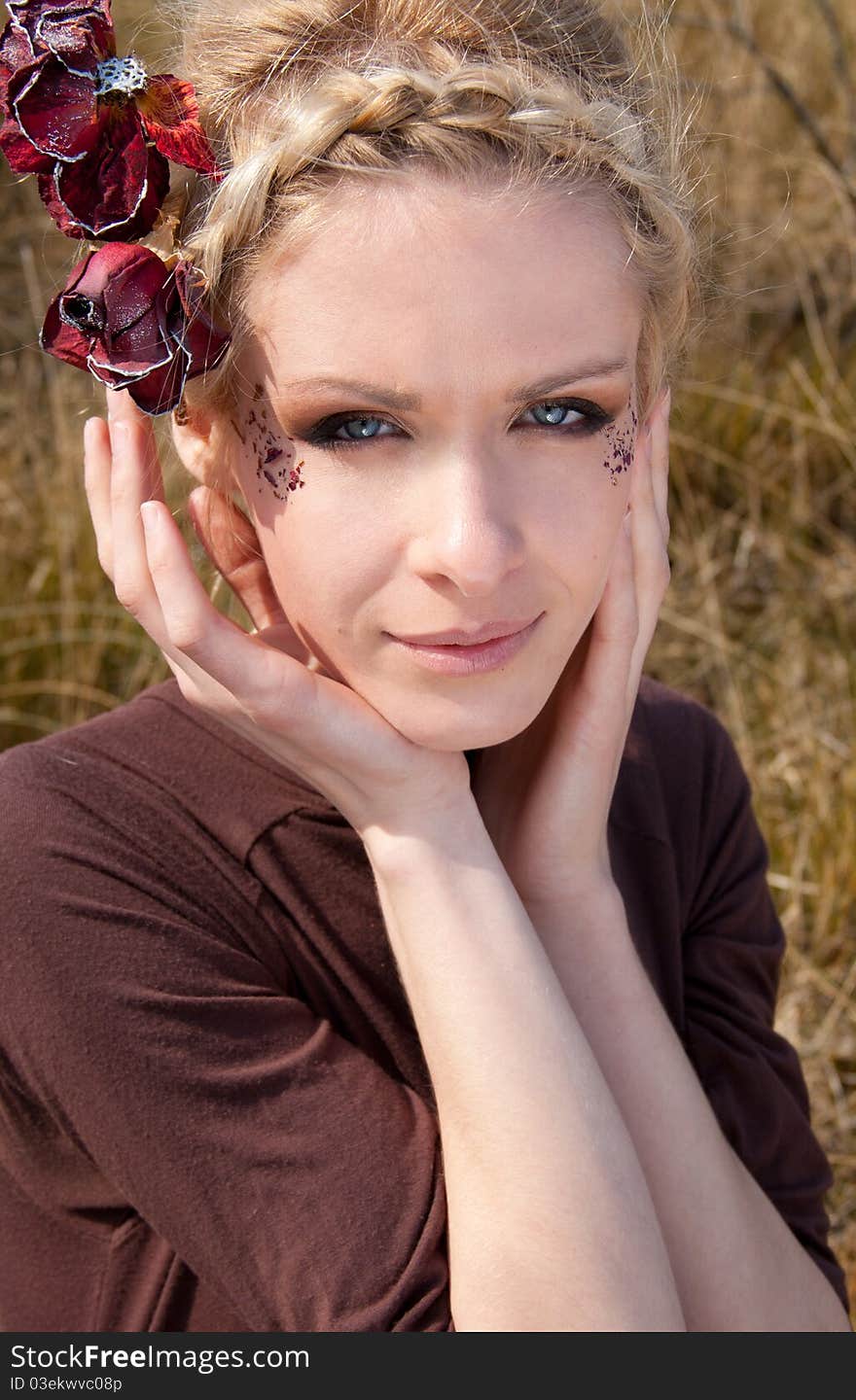 Outdoor portrait of young beautiful blond slim girl in the reed zone of the park. Outdoor portrait of young beautiful blond slim girl in the reed zone of the park